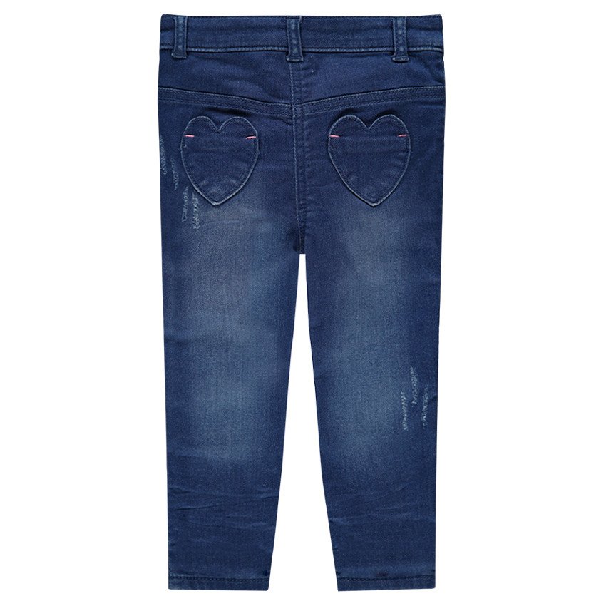 Jeans effet used avec broderies sur les genoux 