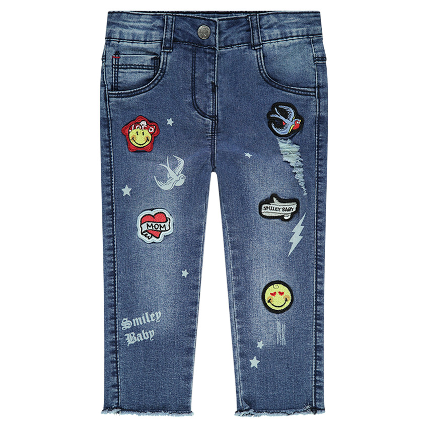 Jeans effet used avec badges Smiley 